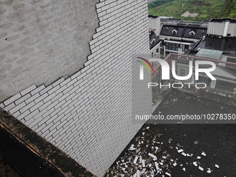 

Tiles are falling off the exterior wall of a high-rise residential building in Yichang, Hubei province, China, on July 19, 2023. With the...