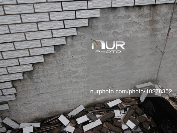 

Tiles are falling off the exterior wall of a high-rise residential building in Yichang, Hubei province, China, on July 19, 2023. With the...