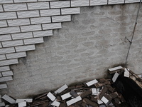 

Tiles are falling off the exterior wall of a high-rise residential building in Yichang, Hubei province, China, on July 19, 2023. With the...