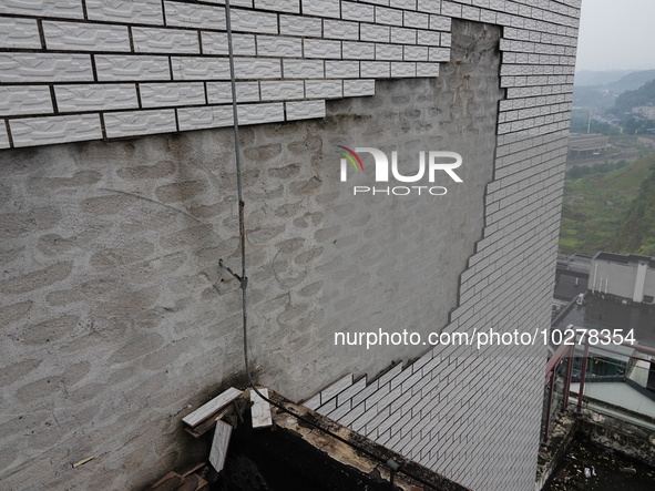 

Tiles are falling off the exterior wall of a high-rise residential building in Yichang, Hubei province, China, on July 19, 2023. With the...