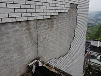 

Tiles are falling off the exterior wall of a high-rise residential building in Yichang, Hubei province, China, on July 19, 2023. With the...