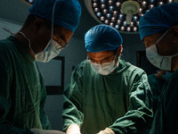 Medical staff perform orthopedic surgery on a patient at the Third People's Hospital in Bijie, Southwest China's Guizhou province, July 13,...