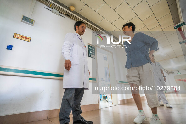 Medical staff encourage patients to keep exercising at the Third People's Hospital in Bijie, Southwest China's Guizhou province, July 13, 20...