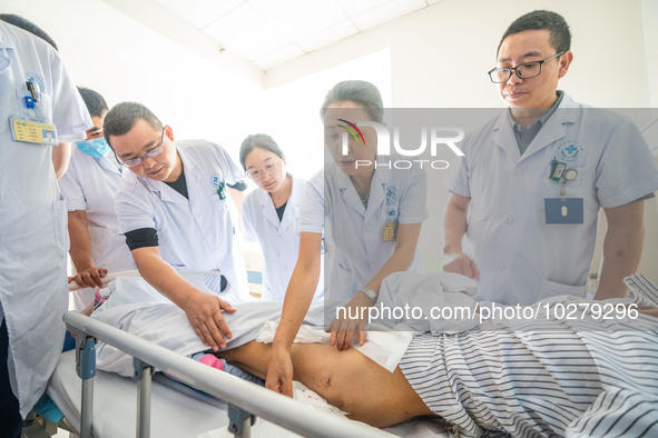 Medical staff discuss the treatment of femoral head necrosis at the First People's Hospital in Bijie, Southwest China's Guizhou province, Ju...