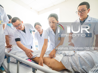 Medical staff discuss the treatment of femoral head necrosis at the First People's Hospital in Bijie, Southwest China's Guizhou province, Ju...