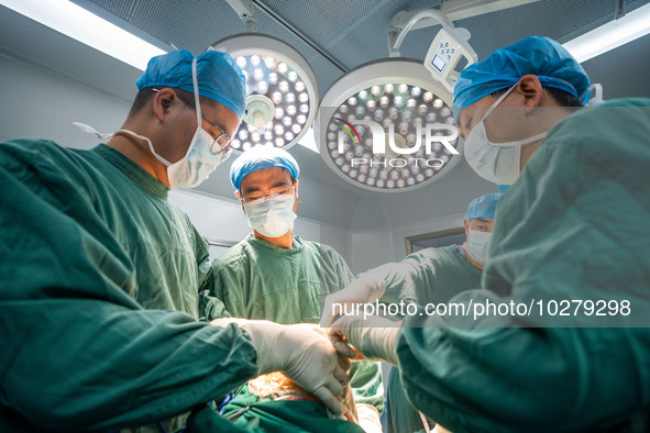 Medical staff perform orthopedic surgery on a patient at the Third People's Hospital in Bijie, Southwest China's Guizhou province, July 13,...