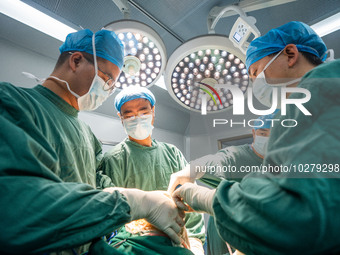 Medical staff perform orthopedic surgery on a patient at the Third People's Hospital in Bijie, Southwest China's Guizhou province, July 13,...