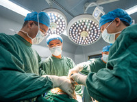 Medical staff perform orthopedic surgery on a patient at the Third People's Hospital in Bijie, Southwest China's Guizhou province, July 13,...