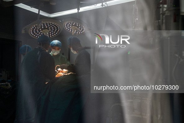 Medical staff perform orthopedic surgery on a patient at the Third People's Hospital in Bijie, Southwest China's Guizhou province, July 13,...