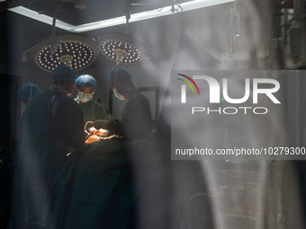 Medical staff perform orthopedic surgery on a patient at the Third People's Hospital in Bijie, Southwest China's Guizhou province, July 13,...