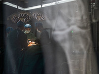 Medical staff perform orthopedic surgery on a patient at the Third People's Hospital in Bijie, Southwest China's Guizhou province, July 13,...