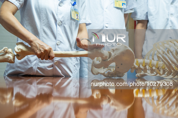 Medical staff discuss the treatment of femoral head necrosis at the First People's Hospital in Bijie, Southwest China's Guizhou province, Ju...