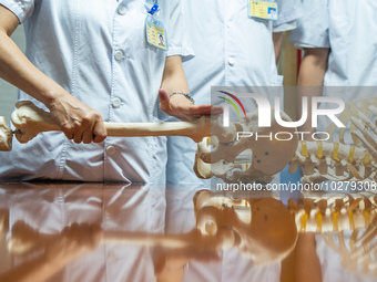 Medical staff discuss the treatment of femoral head necrosis at the First People's Hospital in Bijie, Southwest China's Guizhou province, Ju...