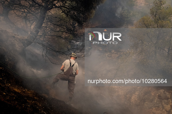 

Firefighters are trying to extinguish a wildfire in Nea Zoi, Nea Peramos, near Megara, Greece on July 19, 2023. After three days, firefigh...