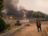 

A burned house in Nea Zoi, Nea Peramos, near Megara, Greece is still being fought by firefighters after three days on July 19, 2023. (