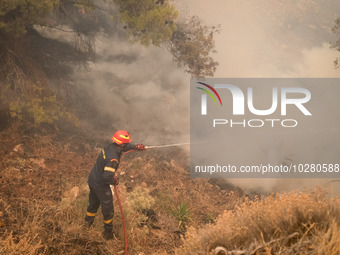 

Firefighters are trying to extinguish a wildfire in Nea Zoi, Nea Peramos, near Megara, Greece on July 19, 2023. After three days, firefigh...