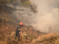 

Firefighters are trying to extinguish a wildfire in Nea Zoi, Nea Peramos, near Megara, Greece on July 19, 2023. After three days, firefigh...