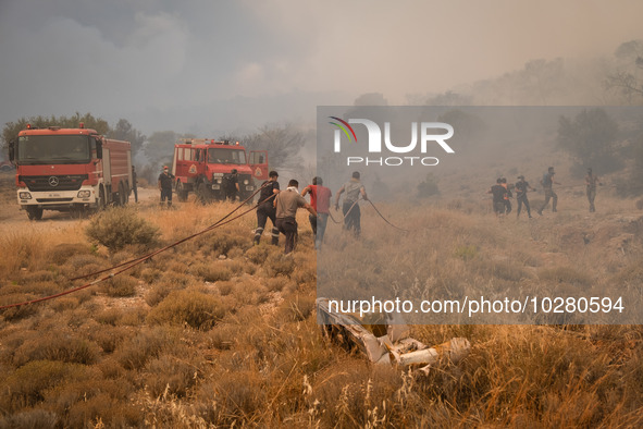 

Firefighters are trying to extinguish a wildfire in Nea Zoi, Nea Peramos, near Megara, Greece on July 19, 2023. After three days, firefigh...