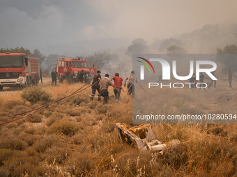 

Firefighters are trying to extinguish a wildfire in Nea Zoi, Nea Peramos, near Megara, Greece on July 19, 2023. After three days, firefigh...