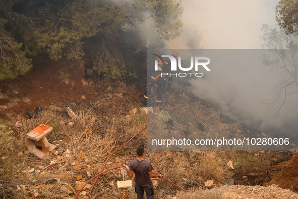 

Firefighters are trying to extinguish a wildfire in Nea Zoi, Nea Peramos, near Megara, Greece on July 19, 2023. After three days, firefigh...