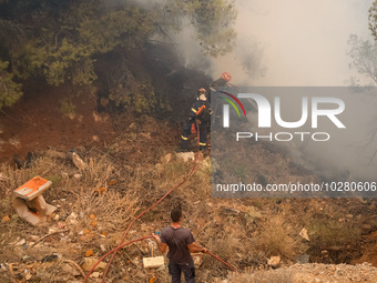 

Firefighters are trying to extinguish a wildfire in Nea Zoi, Nea Peramos, near Megara, Greece on July 19, 2023. After three days, firefigh...