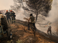 

Firefighters are trying to extinguish a wildfire in Nea Zoi, Nea Peramos, near Megara, Greece on July 19, 2023. After three days, firefigh...