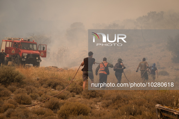 

Locals are helping firefighters to extinguish the fire in Nea Zoi in Nea Peramos, a place near Megara, Greece on July 19, 2023. After thre...