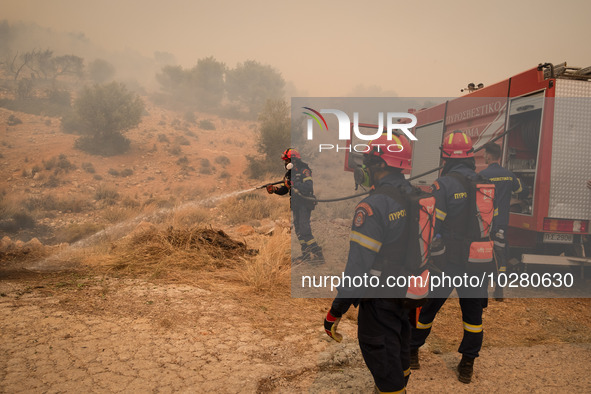 

Firefighters are trying to extinguish a wildfire in Nea Zoi, Nea Peramos, near Megara, Greece on July 19, 2023. After three days, firefigh...