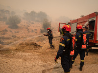 

Firefighters are trying to extinguish a wildfire in Nea Zoi, Nea Peramos, near Megara, Greece on July 19, 2023. After three days, firefigh...