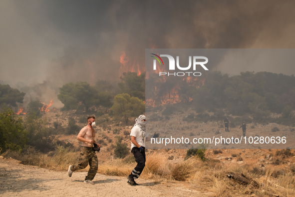 

Locals are helping firefighters to extinguish the fire in Nea Zoi in Nea Peramos, a place near Megara, Greece on July 19, 2023. After thre...