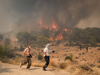 

Locals are helping firefighters to extinguish the fire in Nea Zoi in Nea Peramos, a place near Megara, Greece on July 19, 2023. After thre...