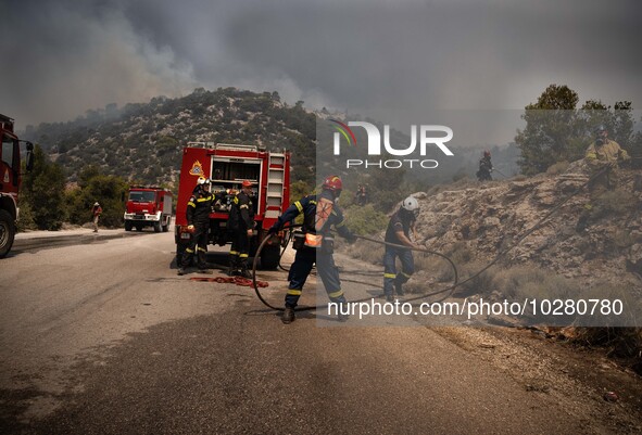 

Athens, Greece, on July 18th, 2023, Greek firefighters are trying to hold their position, blocking the flames from proceeding from Derveno...