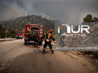 

Athens, Greece, on July 18th, 2023, Greek firefighters are trying to hold their position, blocking the flames from proceeding from Derveno...