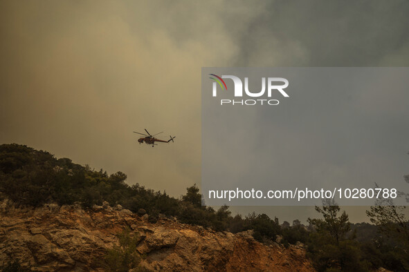 

Athens, Greece, on July 18th, 2023, a firefighting helicopter is approaching the wildfire of Dervenohoria. 