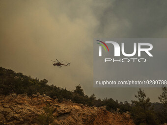 

Athens, Greece, on July 18th, 2023, a firefighting helicopter is approaching the wildfire of Dervenohoria. (