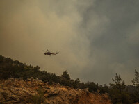 

Athens, Greece, on July 18th, 2023, a firefighting helicopter is approaching the wildfire of Dervenohoria. (