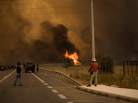 

Athens, Greece, on July 18th, 2023, strong winds are carrying the ravaging flames during the Dervenohoria wildfire (Western Attica, near t...