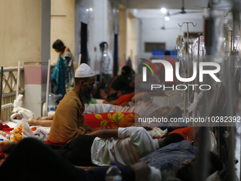 A man offers prayer as he suffering from dengue fever being treated at a government hospital in Dhaka, Bangladesh on July 20. 2023. More tha...