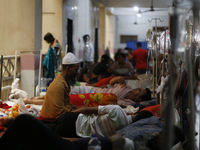 A man offers prayer as he suffering from dengue fever being treated at a government hospital in Dhaka, Bangladesh on July 20. 2023. More tha...