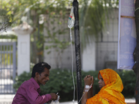 A woman suffering from dengue fever takes a rest under the tree at a government hospital in Dhaka, Bangladesh on July 20. 2023. More than 10...