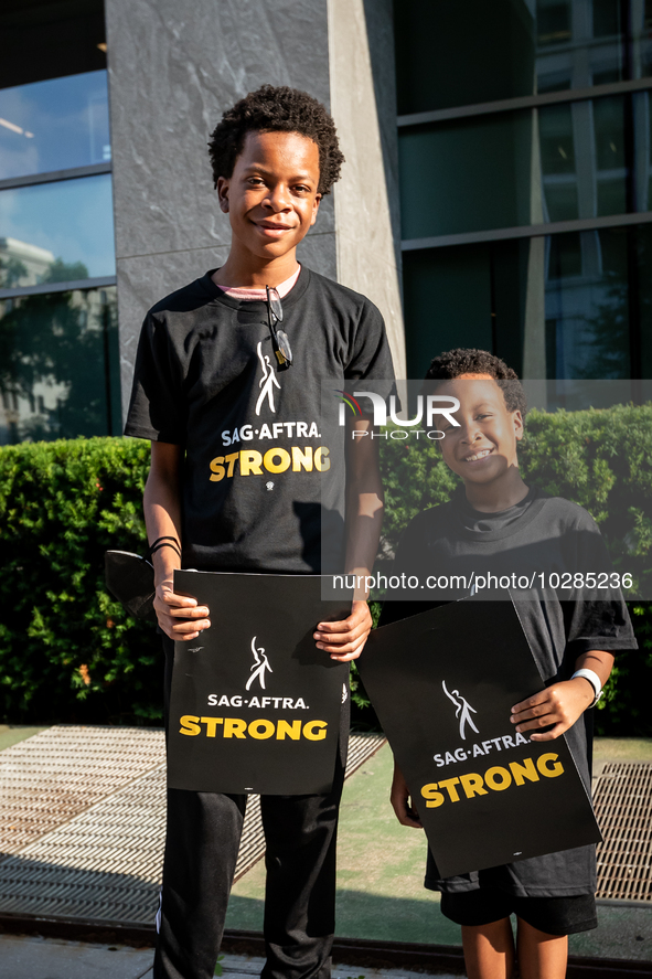 Malachi (left) and Kendrick White picket a Barbie screening with SAG-AFTRA actors and other union members.  The two brothers, ages 13, and 6...