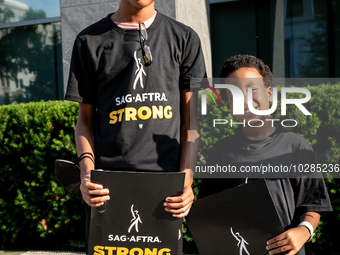 Malachi (left) and Kendrick White picket a Barbie screening with SAG-AFTRA actors and other union members.  The two brothers, ages 13, and 6...