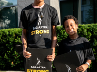 Malachi (left) and Kendrick White picket a Barbie screening with SAG-AFTRA actors and other union members.  The two brothers, ages 13, and 6...