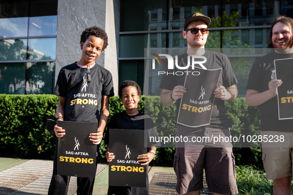 Malachi (left) and Kendrick White picket a Barbie screening with SAG-AFTRA actors and other union members.  The two brothers, ages 13, and 6...