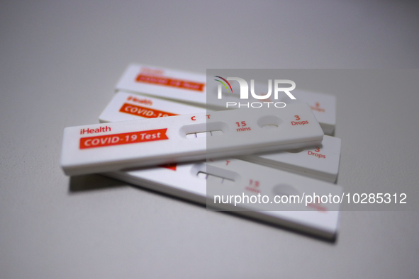 A pile of positive iHealth COVID-19 Antigen Rapid Tests is seen on July 20, 2023 in Houston, Texas.  