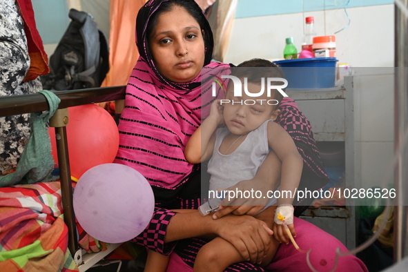 

Patients suffering from dengue fever are being treated inside the Mugdha General Hospital's admission section in Dhaka, Bangladesh on July...