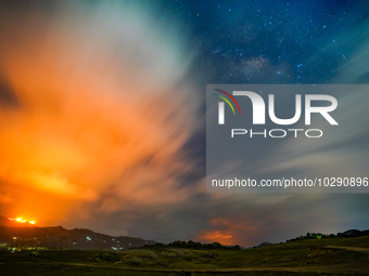 A mountain wildfire and milky way seen from a Teldeniya old town in Kandy, Sri Lanka, on July  22, 2023 (