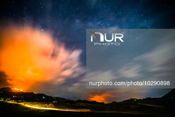 A mountain wildfire and milky way seen from a Teldeniya old town in Kandy, Sri Lanka, on July  22, 2023 