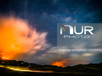 A mountain wildfire and milky way seen from a Teldeniya old town in Kandy, Sri Lanka, on July  22, 2023 (