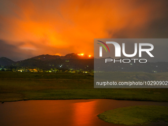 A mountain wildfire and milky way seen from a Teldeniya old town in Kandy, Sri Lanka, on July  22, 2023 (